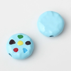 Detail of light blue alloy beads with colorful hand-painted patterns for DIY jewelry making