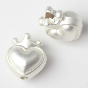 Macro view of matte silver crown heart charm with detailed hole for DIY jewelry making