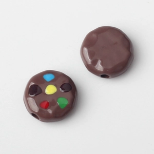 Macro detail of chocolate cookie style spacer beads with colorful candy dots for DIY jewelry