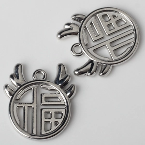 Macro shot of silver alloy antler circle pendant with Fu character for DIY jewelry
