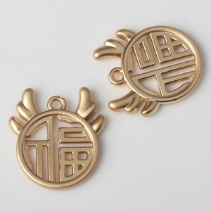 Detailed close-up of golden alloy Fu character charms with antler accents for DIY jewelry