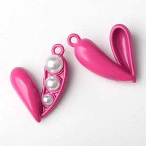 Detail of pink alloy pea pod pendant with three white pearls for DIY jewelry making
