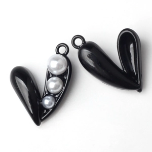 Macro detail of black V-shaped pearl pendants for DIY necklaces and jewelry making