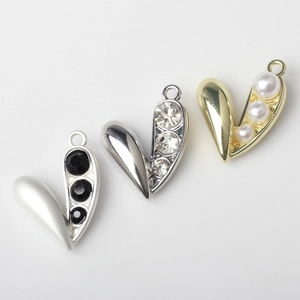 Three alloy heart pendants with pearls and rhinestones in gold and silver finishes