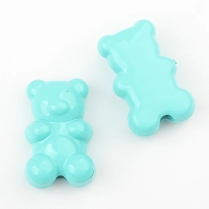 Macro detail of two light blue bear charms for DIY jewelry making with a glossy finish