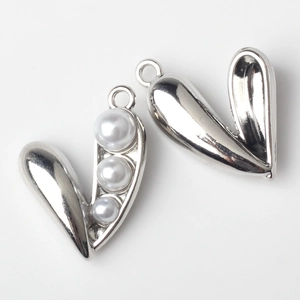 Detail of silver alloy heart pendant with three gradient pearls and circular hanging ring
