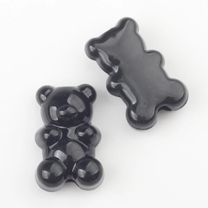 Detail of glossy black bear-shaped charms for DIY jewelry making and crafting