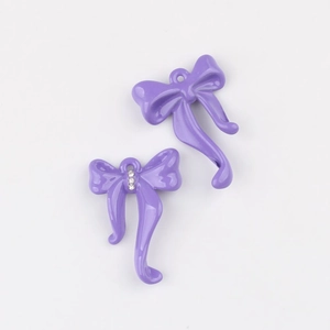 Detalle de colgantes de lazo morado con cristal para diseño de joyería artesanal