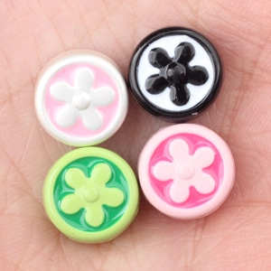 Minimalist colorful enamel flower beads for DIY jewelry making on human palm