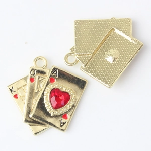 Detail view of gold alloy poker cards pendant with red heart rhinestone and back texture