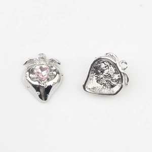 Detail eines Erdbeer-Anhängers mit rosa Herz-Edelstein und silberner Metallstruktur