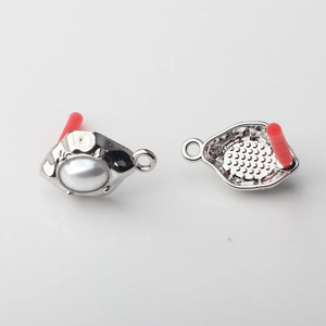 Detailed view of silver alloy earring charms with white resin pearl and honeycomb texture