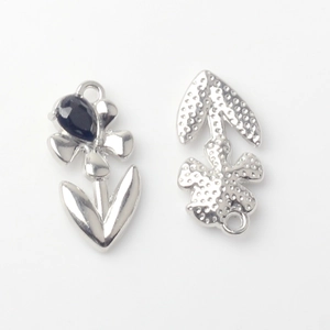 Macro detail of alloy flower charm showing front polished surface and back hammered texture
