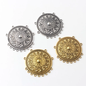 Detail of vintage geometric alloy sunflower connectors in antique silver and gold