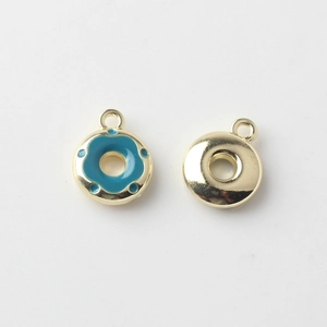 Detail of mini gold-plated alloy donut charms with blue enamel finish for DIY jewelry