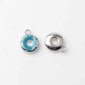 Detailed view of donut pendants with blue enamel finish and polished silver back for DIY jewelry