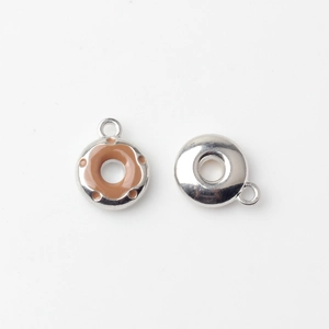 Detailed macro view of two mini alloy donut charms for DIY jewelry making and crafts