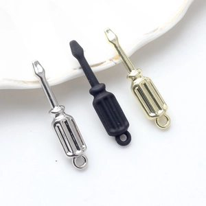 Close-up of alloy screwdriver pendants in gold, silver, and black for DIY jewelry crafts