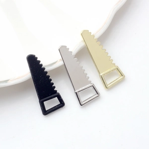 Close-up of DIY alloy mini saw charms in black, gold and silver for jewelry making