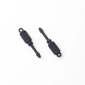 Macro shot of two mini black screwdriver charms with matte finish for DIY jewelry crafts