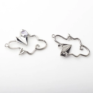 Detail view of silver cloud and paper plane charms with a purple gem for DIY jewelry