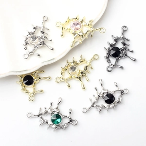 Macro shot of colorful rhinestone eye charms in liquid metal frames for DIY jewelry