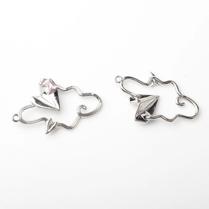 Detail of silver alloy cloud and paper airplane charms with pink gemstone for DIY jewelry