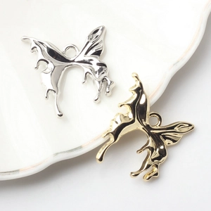 Detail of liquid metal butterfly charms in gold and silver for DIY jewelry making