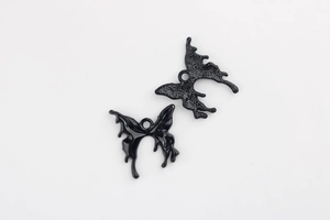 Macro view of fluid butterfly charms showing mirror polished front and matte textured back