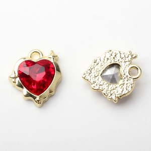 Front and back detail of a gold heart pendant with a faceted red gemstone for jewelry making