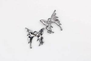 Detailed macro view showing polished front and matte back of butterfly charms