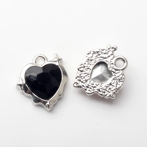 Gothic heart pendant featuring black gemstone and silver alloy back with hammered texture