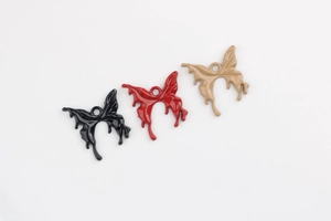 Detailed macro of alloy butterfly pendants with enamel liquid effect and hanging holes