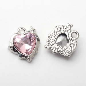 Front and back detail of pink heart charms with star prongs and hammered silver texture