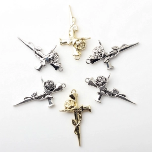 Detailed view of alloy rose cross pendants in gold and silver for DIY jewelry making