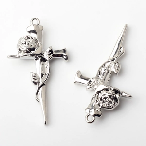 Macro shot of silver alloy cross pendants with detailed rose carvings for DIY jewelry making