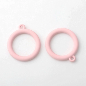 Close-up of matte pink hollow circle alloy pendants for DIY handmade jewelry earrings