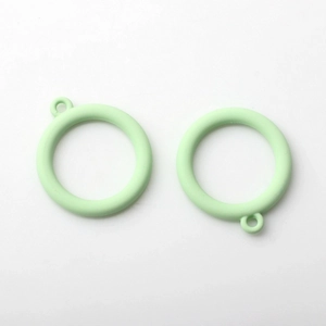 Macro shot of mint green alloy circle pendants with matte finish for DIY jewelry making