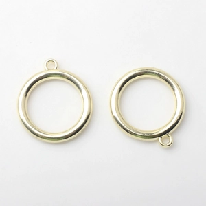Close-up of golden alloy hollow circle charms for DIY earring and jewelry making