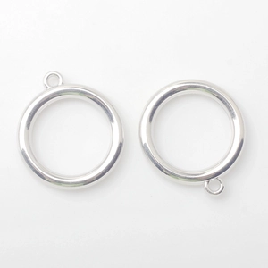 Detailed macro view of silver alloy hollow circle pendants with hanging hole for DIY crafts