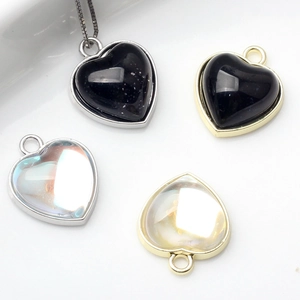 Fashion heart pendants in black and iridescent glass with gold and silver alloy frames
