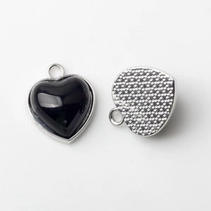 Detail of heart pendant with black gemstone and textured silver backing for DIY jewelry