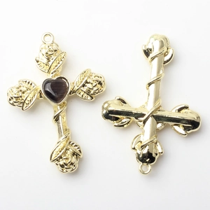 Detailed front and back view of golden alloy cross charms with rose relief and heart stone