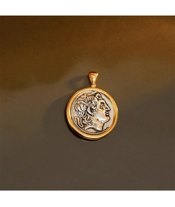 Macro view of vintage Alexander the Great coin pendant in gold and silver dual-tone finish