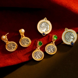 Vintage French coin jewelry set with gold plating, pearls and emerald gemstones on velvet