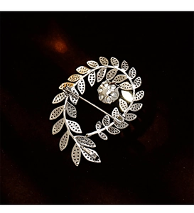 Macro shot of silver wheat ear brooch back view showing secure needle clasp and craft