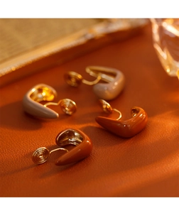 Detail view of u-shaped spiral ear clips in Morandi enamel colors and gold finish