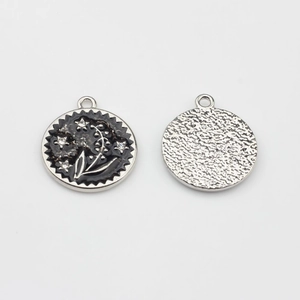 Detailed view of black enamel flower pendant with rhinestones for DIY jewelry