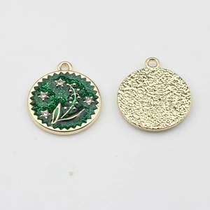 Detail of green enamel flower pendant with white rhinestones for DIY jewelry making
