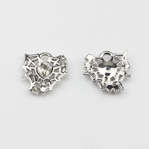 Front and back detail of hollow heart charms with mesh pattern and zircon stones